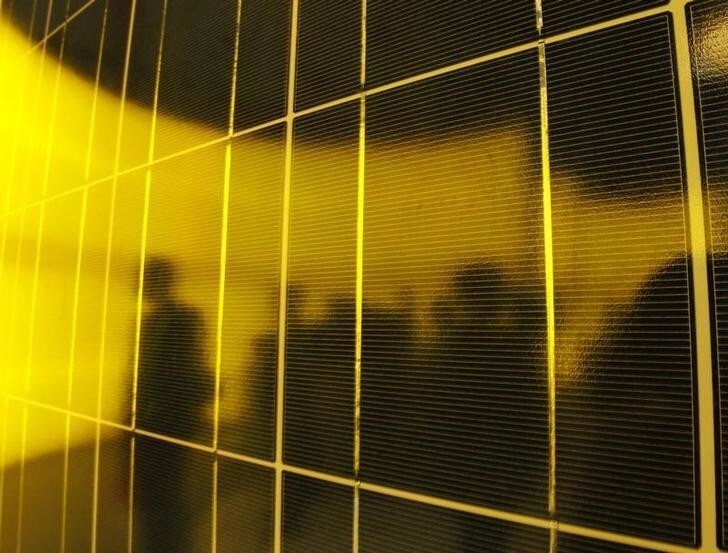 People are silhouetted on a solar panel display by solar module supplier Upsolar at the fourth International Photovoltaic Power Generation (PV) Expo in Tokyo March 2, 2011. More than 600 companies in the solar energy business from 18 countries are taking part in the March 2-4 expo, which showcases firms and products related to photovoltaic power generation. REUTERS/Yuriko Nakao (JAPAN - Tags: BUSINESS SCI TECH ENVIRONMENT)