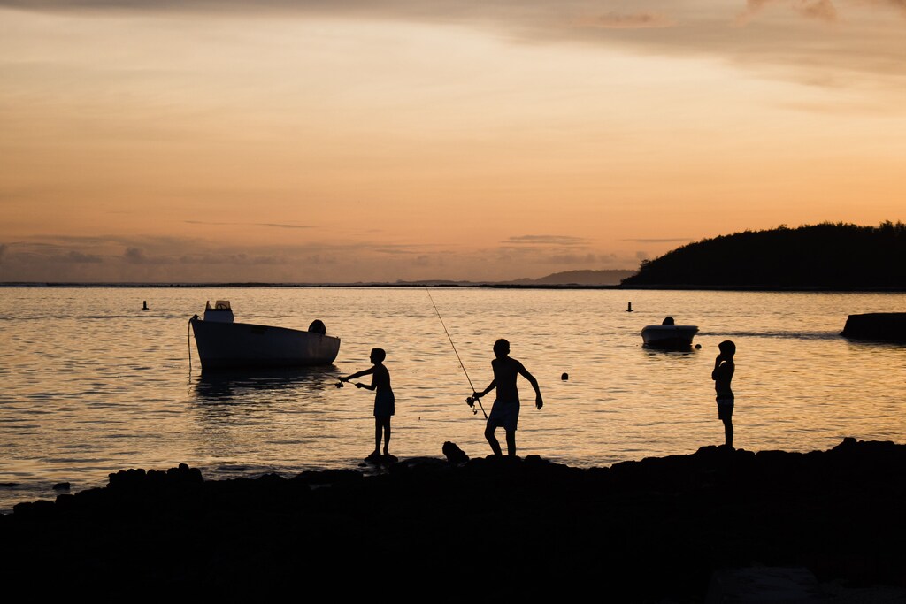 children fish in the ocean off mauritius. Caption: By recognizing the expertise of Indigenous people and local communities, we can shift the global conversation from tropical crises to tropical opportunities.