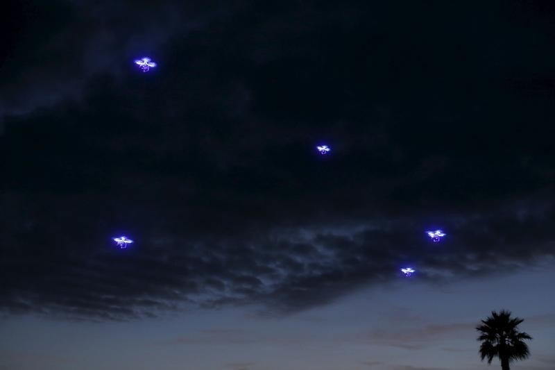 Drones fly in synchronization above attending conference goers as they dine outside along the ocean during the opening remarks at the beginning of the Wall Street Journal Digital Live ( WSJDLive ) conference at the Montage hotline Laguna Beach, California October 19, 2015. REUTERS/Mike Blake TPX IMAGES OF THE DAY - GF10000251478