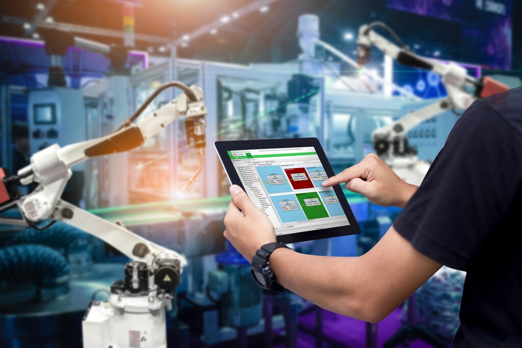 Man operating automated tooling machine on an ipad.