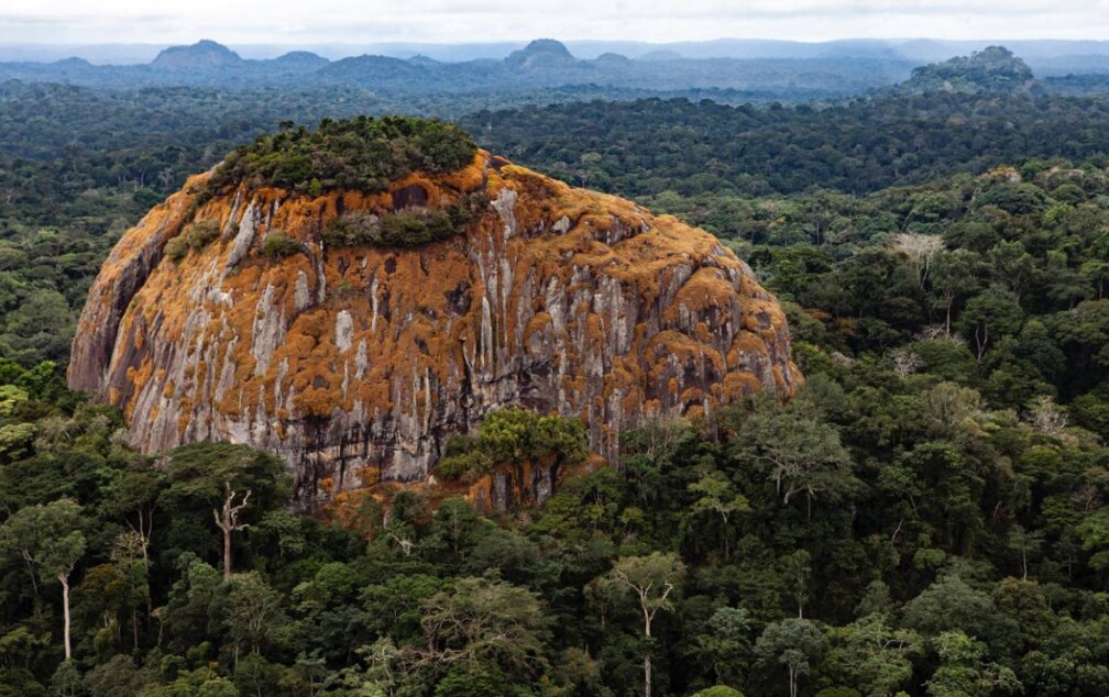 A large rock juts out from the tropical rainforest in the central African country of Gabon, 23 August 2012, Gabon. Josh Ponte/Handout via Thomson Reuters Foundation