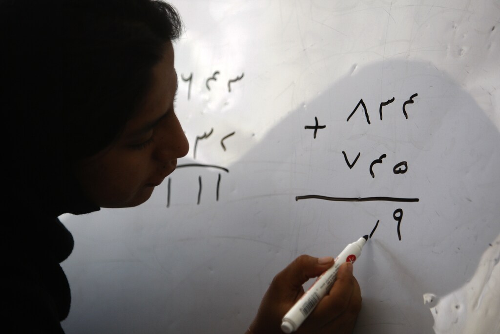 A woman takes part in a math class at the Family Guidance Center women's shelter in Kabul, August 9, 2009. According to a 2006 report by the UK-based NGO 'Womankind,' anywhere between sixty and eighty percent of marriages in Afghanistan are forced, 57 percent of brides are under the age of 16, and 87 percent complain of domestic violence. Afghan women suffer from the lowest literacy rate in the world, at 13 percent. REUTERS/Lucy Nicholson (AFGHANISTAN SOCIETY EDUCATION) - GM1E5891MAI01