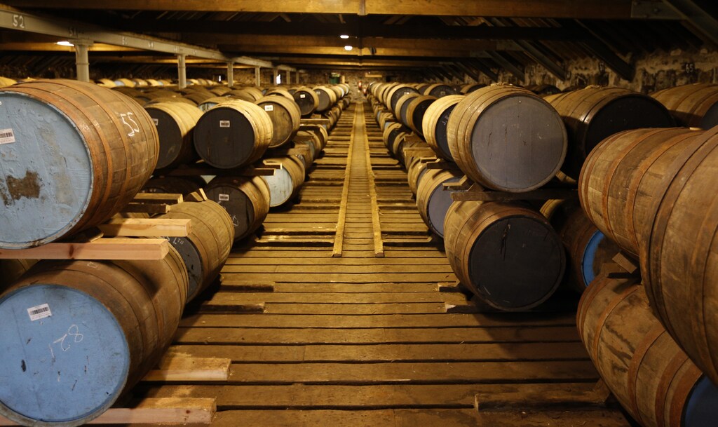 Whisky barrels are seen in the warehouse of the Diageo Cardhu distillery in Scotland March 21, 2014. Scotch whisky distillers are burning their unwanted grain byproducts, wood chips and other types of biomass for a source of energy in remote areas of the Highlands, where gas links are scarce and fuel oil is pricey. The production of Scotch whisky has evolved over more than 500 years and is steeped in tradition. It is also a big business, generating 4 billion pounds ($6 billion) a year in exports - a quarter of all Britain's food and drink sales abroad. Photograph taken March 21, 2014. REUTERS/Russell Cheyne (BRITAIN BUSINESS - Tags: BUSINESS ENERGY ENVIRONMENT FOOD) - RTR3JX6V