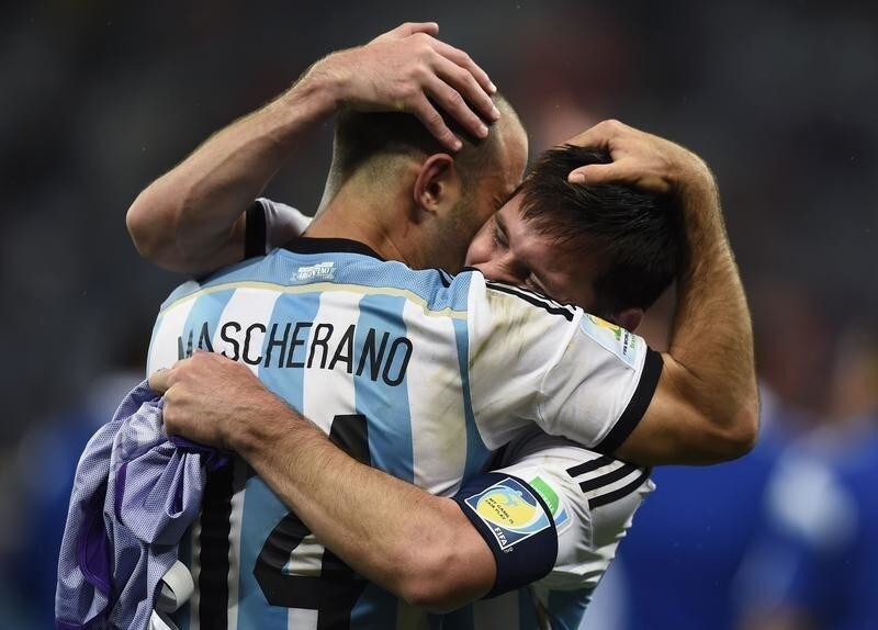 Argentina's Javier Mascherano hugs teammate Lionel Messi (back) after their team's victory over the Netherlands at the end of their 2014 World Cup semi-finals at the Corinthians arena in Sao Paulo July 9, 2014. REUTERS/Dylan Martinez (BRAZIL - Tags: SOCCER SPORT WORLD CUP TPX IMAGES OF THE DAY) - RTR3XXCE