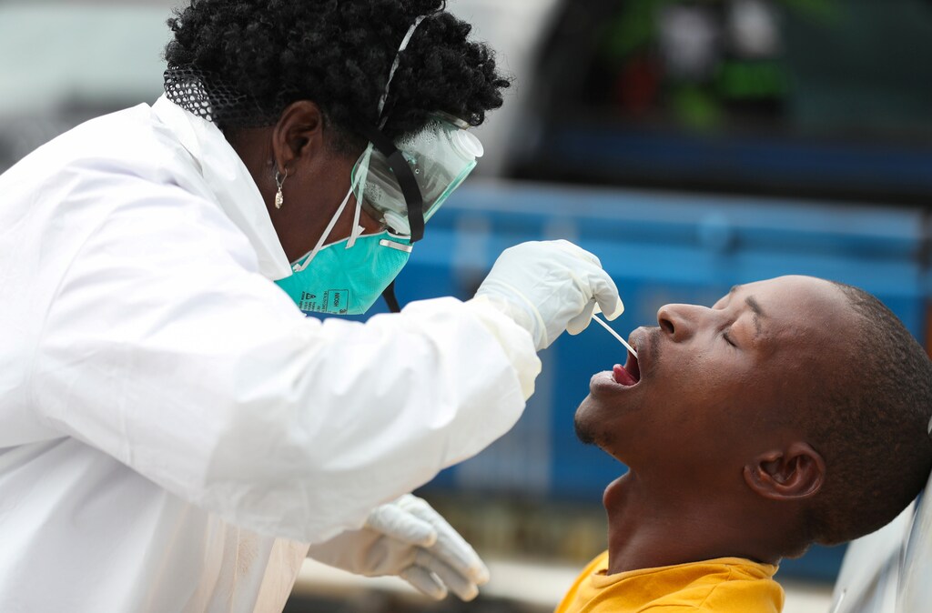 A member of medical staff swabs the mouth of a resident as she is testing him for a virus, during a nationwide lockdown for 21 days to try to contain the coronavirus disease (COVID-19) outbreak, in Alexandra, South Africa, March 31, 2020. REUTERS/Siphiwe Sibeko - Coronavirus china virus health healthcare who world health organization disease deaths pandemic epidemic worries concerns Health virus contagious contagion viruses diseases disease lab laboratory doctor health dr nurse medical medicine drugs vaccines vaccinations inoculations technology testing test medicinal biotechnology biotech biology chemistry physics microscope research influenza flu cold common cold bug risk symptomes respiratory china iran italy europe asia america south america north washing hands wash hands coughs sneezes spread spreading precaution precautions health warning covid 19 cov SARS 2019ncov wuhan sarscow wuhanpneumonia pneumonia outbreak patients unhealthy fatality mortality elderly old elder age serious death deathly deadly