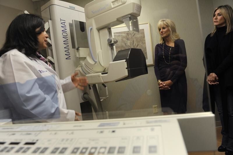 (L-R) Dr. Costanza Cocilovo gives Jill Biden, wife of U.S. Vice President Joe Biden, and actress Jennifer Aniston a tour of a mammography lab at the INOVA Breast Care Institute in Alexandria, Virginia, October 3, 2011. Aniston is visiting Washington to raise awareness with a screening of her Lifetime Original movie "Five," an anthology of five short films exploring the impact of breast cancer on people's lives.