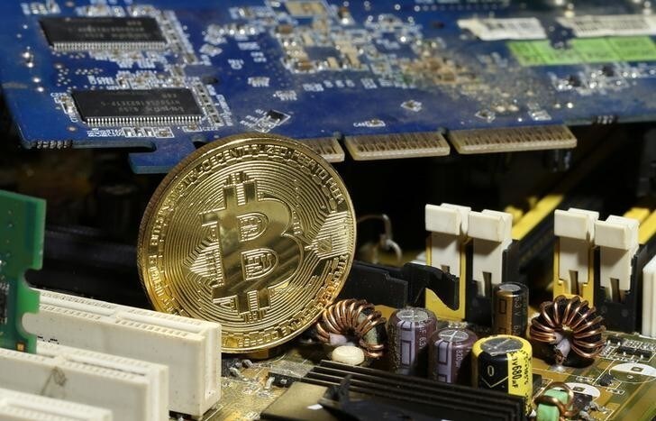 A copy of bitcoin standing on PC motherboard is seen in this illustration picture, October 26, 2017. Picture taken October 26, 2017. REUTERS/Dado Ruvic