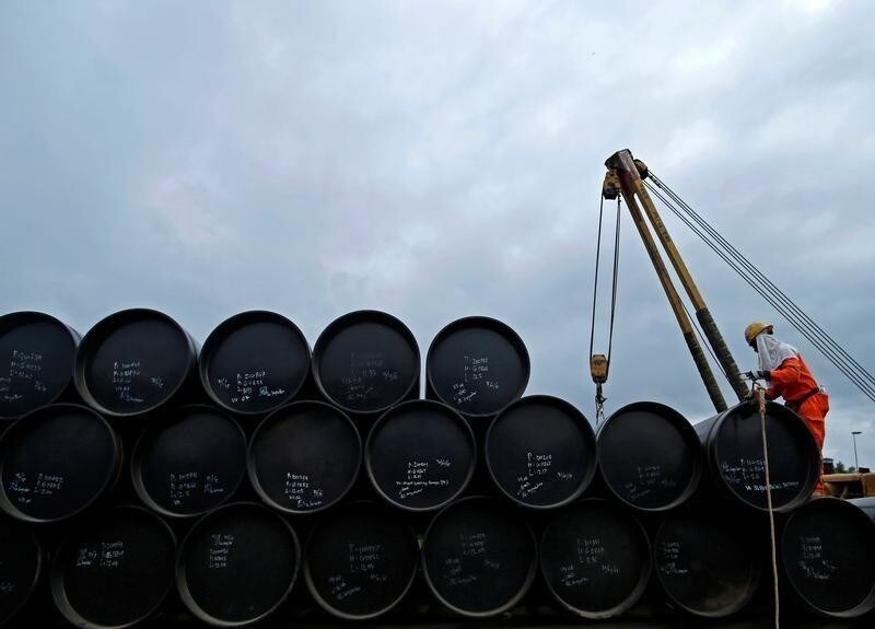 A worker prepares to transport oil pipelines to be laid for the Pengerang Gas Pipeline Project at an area 40km (24 miles) away from the Pengerang Integrated Petroleum Complex in Pengerang, Johor, February 4, 2015. REUTERS/Edgar Su/File Photo