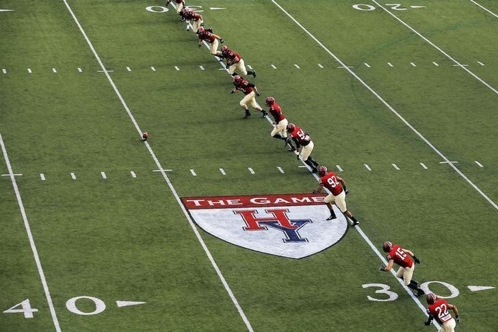 The Harvard University football team kicks off during their football game against Yale University at Harvard in Cambridge, Massachusetts November 22, 2014. Known as "The Game," the first Harvard versus Yale football game was played in 1875, making it one of the oldest rivalries in college sports. REUTERS/Brian Snyder (UNITED STATES - Tags: EDUCATION SPORT FOOTBALL)