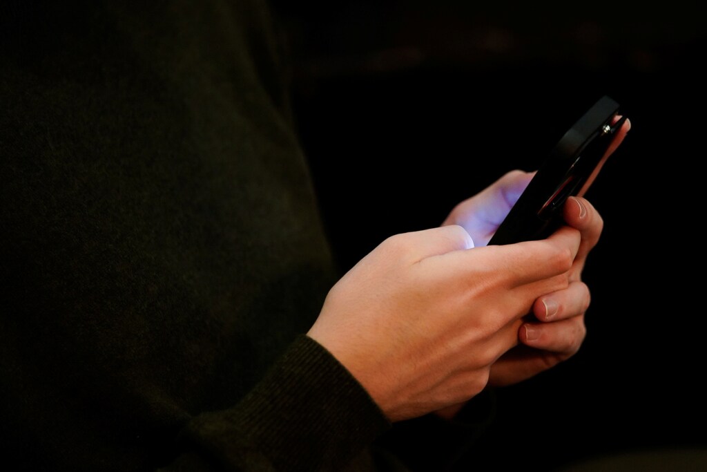 Josh Joffe a 23-year-old Jewish American, sits with the phone he uses to access social media and see posts about the Israel-Palestinian conflict at his home in Washington, U.S., October 15, 2023. REUTERS/Elizabeth Frantz