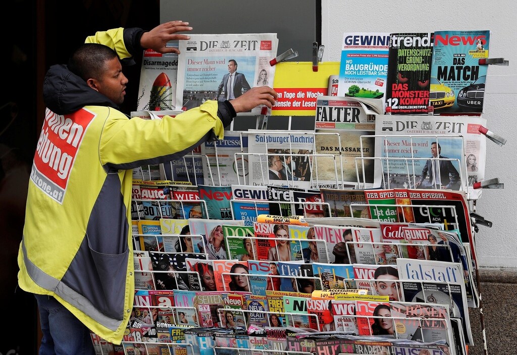 A newspaper seller adjusts papers at his stand in the centre of Vienna, Austria, May 4, 2018. REUTERS/Heinz-Peter Bader - RC1CED3D9560