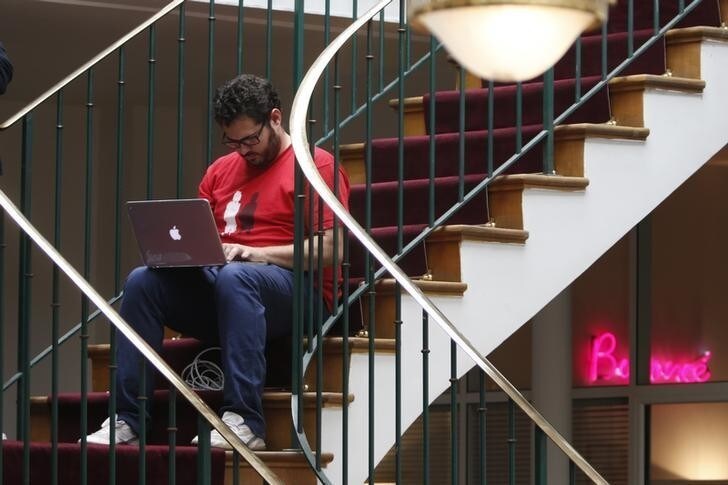 A entrepreneur works at his computer laptop at the so-called "incubator" of French high-tech start-ups "TheFamily" in Paris, France, July 27, 2015. REUTERS/Charles Platiau