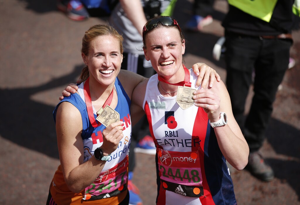 Britain Athletics - London Marathon - London - 23/4/17 Great Britain Olympic rower Helen Glover and Heather Stanning celebrate with their medals after finishing the marathon Action Images via Reuters / Matthew Childs Livepic - RTS13J2P