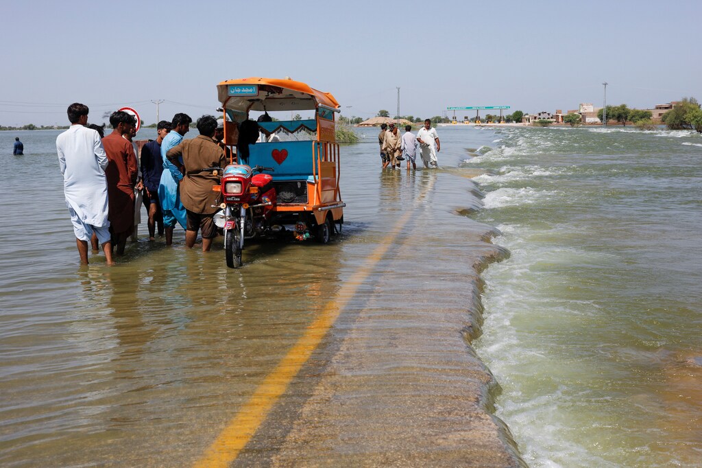 Displaced people on a flooded highway in Sehwan, Pakistan.