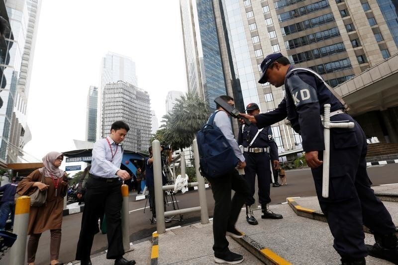 Security guards screen workers as they go into the Indonesia Stock Exchange building in Jakarta, Indonesia, January 16, 2018. REUTERS/Beawiharta - RC1D5FB18C50