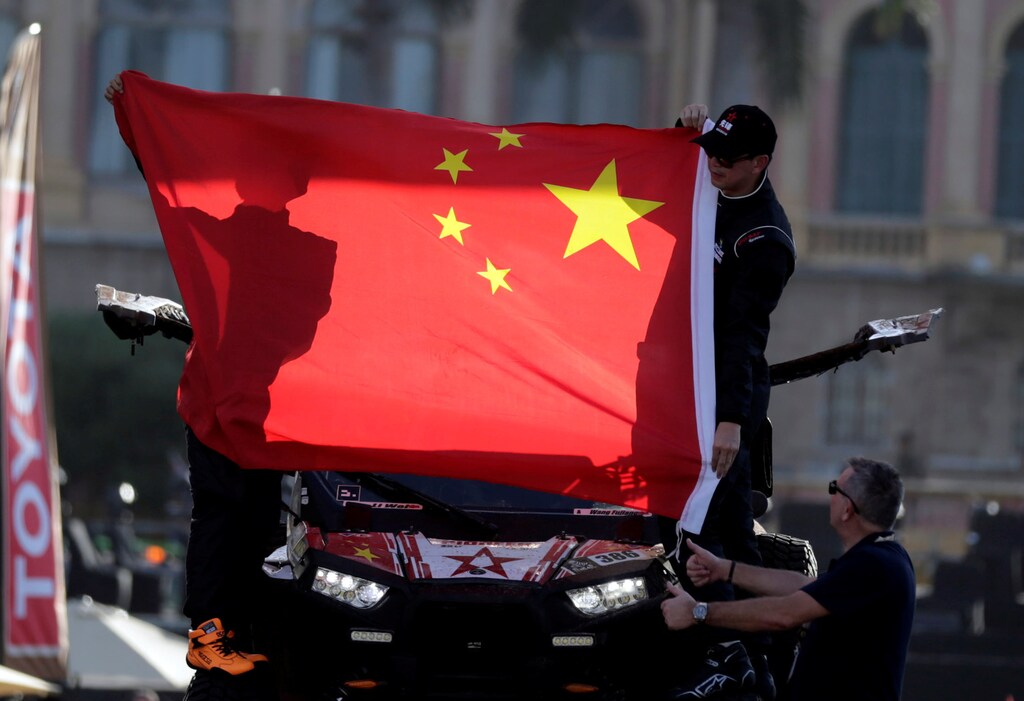 Dakar Rally - 2017 Paraguay-Bolivia-Argentina Dakar rally - 39th Dakar Edition - Departure Ceremony - Asuncion, Paraguay 01/01/17. Wang Fujiang (R) and Li Wei of China wave from their Polaris from the podium. REUTERS/Jorge Adorno - RTX2X6R9