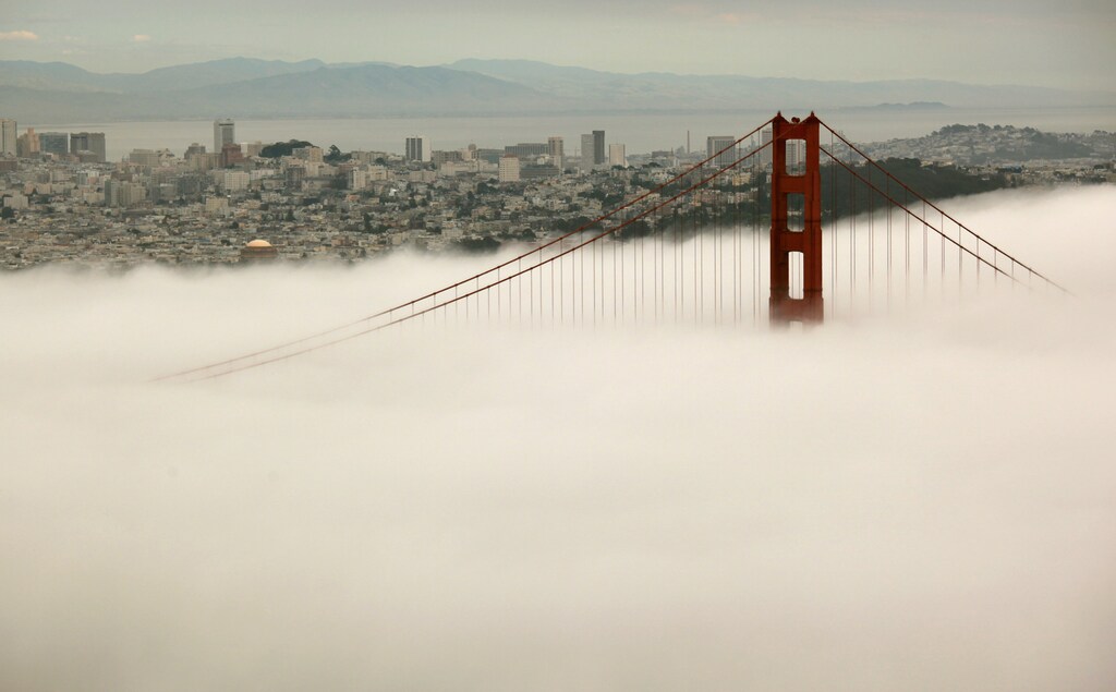 The skyline of San Francisco and the south tower of the Golden Gate Bridge are seen from the Marin Headlands as they rise above the fog in Sausalito, California March 21, 2012. A celebration held over the Memorial Day weekend in May will commemorate the bridge's 75th anniversary this year.