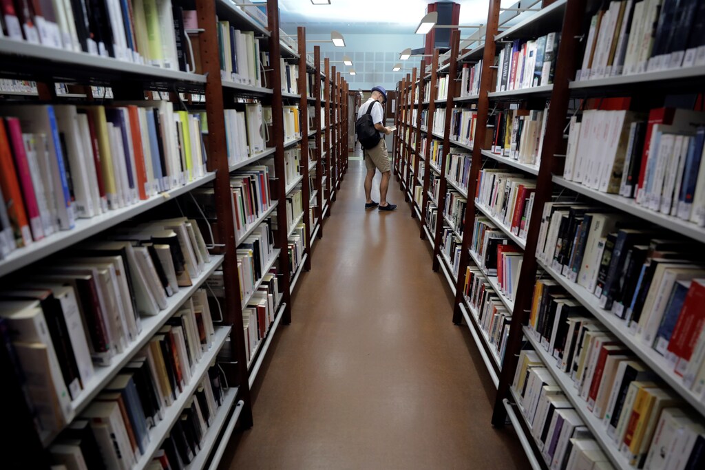 A man looks at books at the "Louis Nucera" library in Nice, France, September 13, 2018. REUTERS/Eric Gaillard - RC162F3B1330