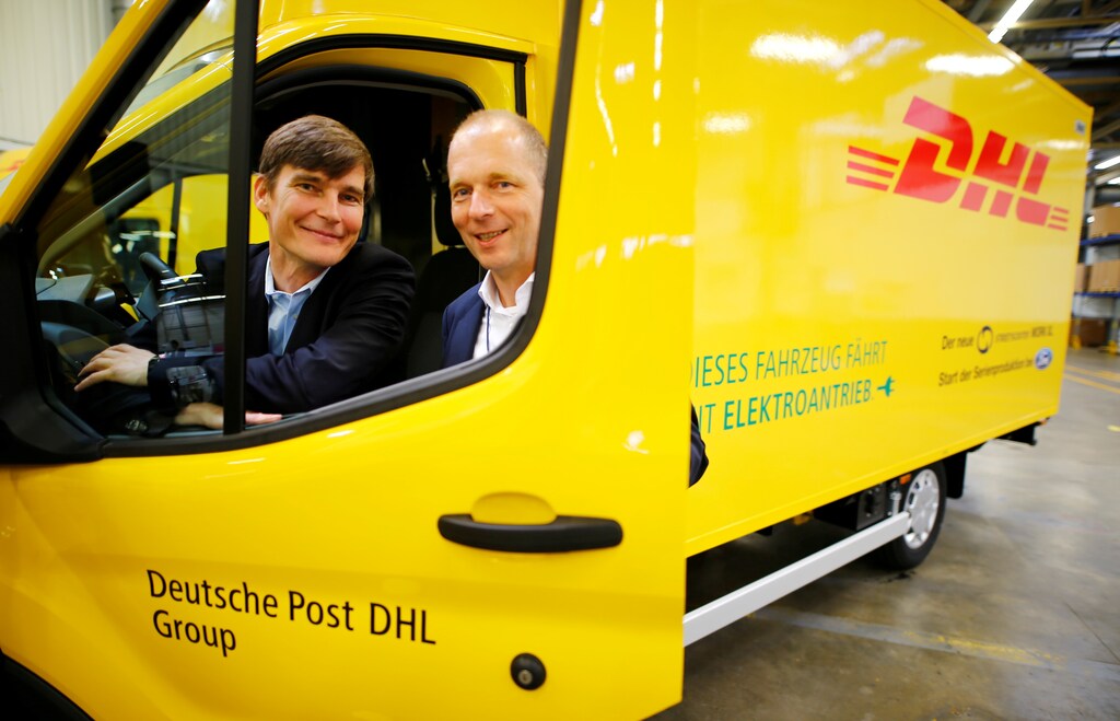 Achim Kampker (L), Chief Executive Officer (CEO) of electric delivery van maker StreetScooter GmbH, a subsidiary of German postal and logistics group Deutsche Post DHL and Joerg Beyer, executive director engineering Ford Europe, jointly pose for a picture from a StreetScooter WORK XL electric van based on a Ford Transit at Ford's new production line in Cologne, Germany October 9, 2018. REUTERS/Wolfgang Rattay - RC1D4FB7E270