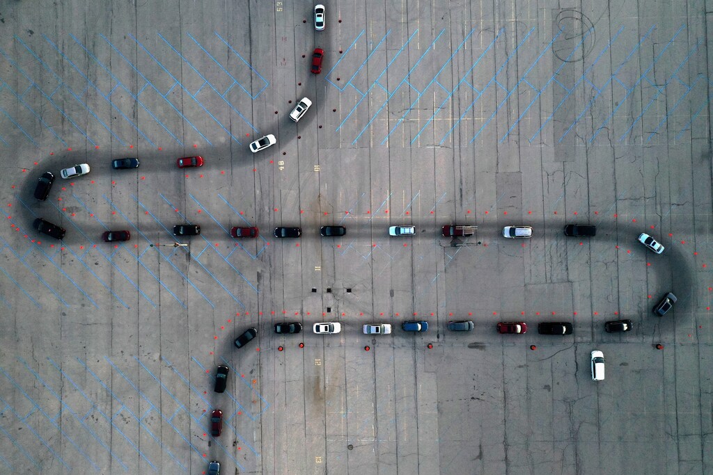 An aerial view of vehicles waiting at a drive-thru COVID-19 testing site in the parking lot of Miller Park, as the coronavirus (COVID-19) disease outbreak continues in Milwaukee, Wisconsin, U.S., November 5, 2020. Picture taken with a drone. REUTERS/Bing Guan TPX IMAGES OF THE DAY - RC2CXJ93Y99M