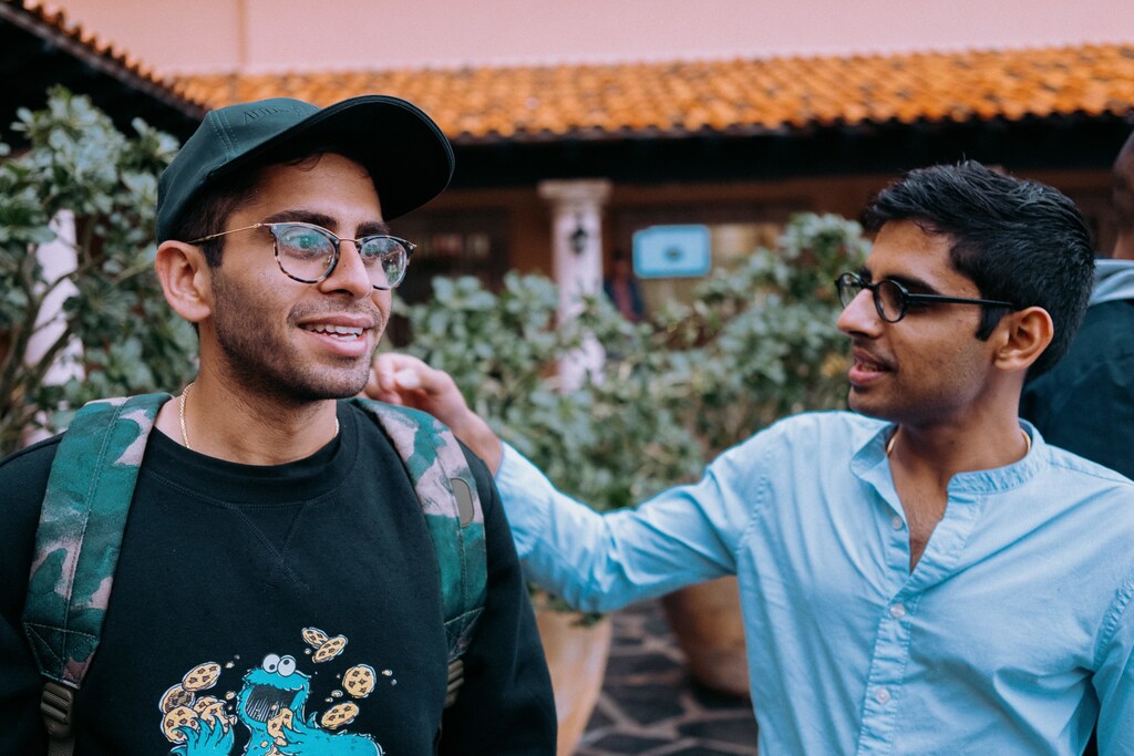One man with his hand on another man's shoulder.