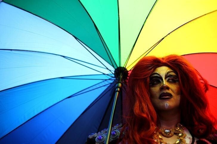 An activist holds umbrella during a parade to demand rights of gender equality to LGBT community members in Santiago, Chile, November 25, 2017. REUTERS/Ivan Alvarado