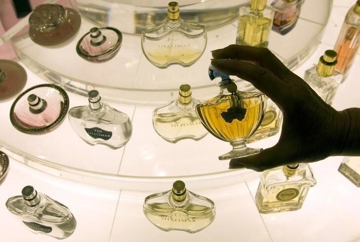 An employee holds a Guerlain's perfume bottle at the KaDeWe department store in Berlin April 15, 2008. The over 100 years old KaDeWe, which stands for Kaufhaus Des Westens and is pronounced kah-day-vay, is the second largest store of its kind in Europe after London's Harrods. Around 50,000 people a day crowd the 60,000 square meters (646,000 square feet) of shopping space over eight floors. The food hall alone covers 7,000 square meters and has about 30,000 different products on offer. REUTERS/Fabrizio Bensch (GERMANY)