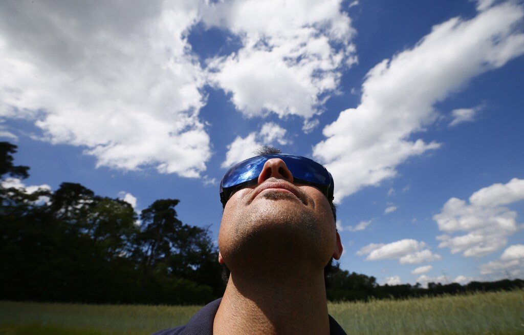 Michael Niesen of MAVinci looks into the sky during the flight of a camera equipped "Sirius" unmanned aerial vehicle (UAV) at a training session for clients on an airfield for model aircraft in Walldorf near Heidelberg, June 13, 2013. MAVinci, based in Leimen near Heidelberg, makes UAVs with a wingspan of 1.6 metres (5.3 feet) that take aerial images for land surveys conducted for infrastructure projects, mines or applications in the building industry. According to the European Commission, there are more than 400 projects across 20 European countries to develop civil UAV ranging from some weighing just a few grammes to others the size of an Airbus A320 jet. More than 80 percent of the companies working on these projects are small and medium-sized businesses or start-ups. Picture taken June 13, 2013. REUTERS/Ralph Orlowski (GERMANY - Tags: TRANSPORT BUSINESS SCIENCE TECHNOLOGY) - RTX10U2P