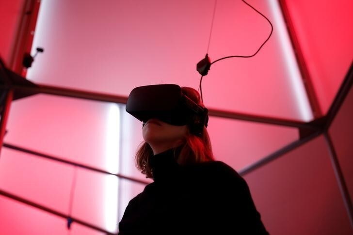 A woman plays a video game with the Oculus Rift VR headset at the mk2 VR, a place dedicated to virtual reality in Paris, France, December 5, 2016. REUTERS/Benoit Tessier