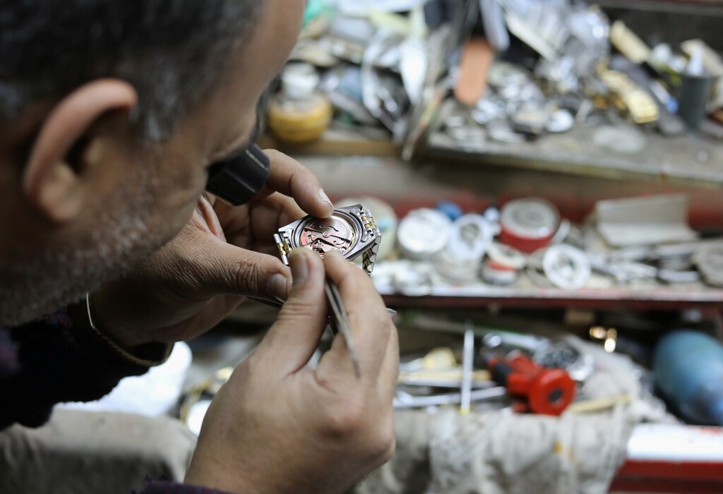 A watchmaker repairs a watch at a workshop in Cairo, Egypt, January 27, 2018. REUTERS/Mohamed Abd El Ghany - RC145C42A170