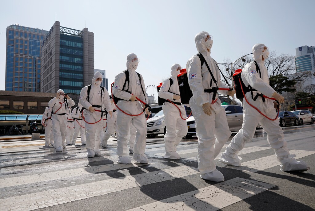 South Korean soldiers wearing protective gear walk on a street in front of the city hall after the rapid rise in confirmed cases of the novel coronavirus disease of (COVID-19) in Daegu, southeast of the capital Seoul, South Korea Coronavirus china virus health healthcare who world health organization disease deaths pandemic epidemic worries concerns Health virus contagious contagion viruses diseases disease lab laboratory doctor health dr nurse medical medicine drugs vaccines vaccinations inoculations technology testing test medicinal biotechnology biotech biology chemistry physics microscope research influenza flu cold common cold bug risk