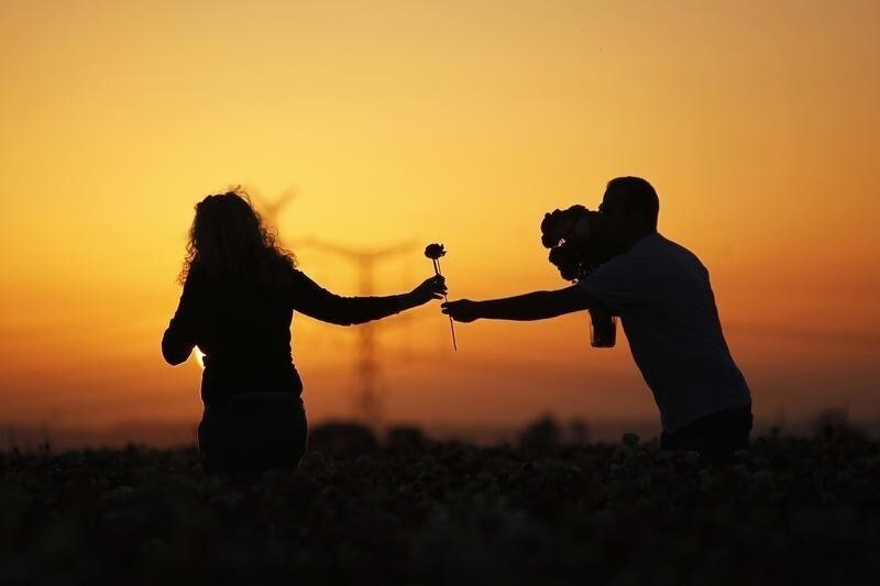 A couple picks buttercup flowers in a field near the southern town of Kiryat Gat April 21, 2012.