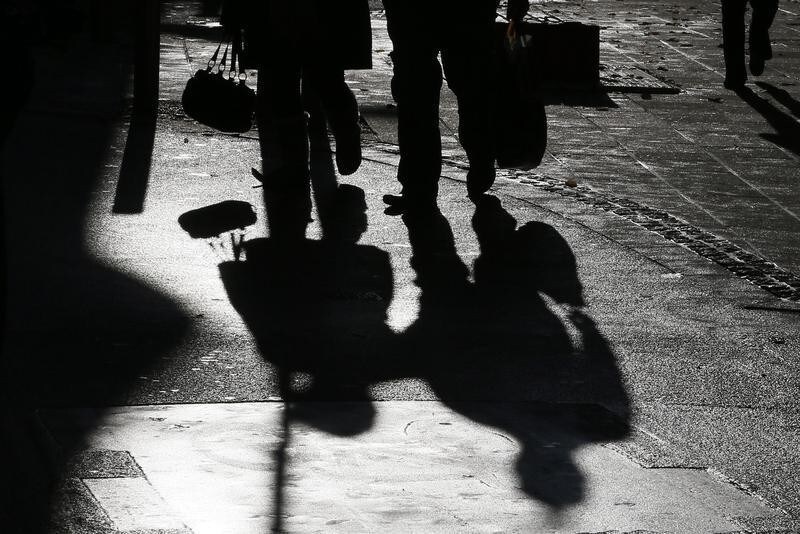 The shadows of shoppers are cast onto the ground in St Helier, Jersey November 13, 2012. Public anger at tax avoidance by corporations and the excesses of the scandal-hit banking sector has emboldened a movement to clip the wings of finance in Jersey, the British offshore tax haven. Since the 1960s the island has developed a formidable offshore banking and finance sector that now accounts for more than two fifths of the economy and those who object are often shouted down. Picture taken November 13, 2012. REUTERS/Stefan Wermuth (JERSEY - Tags: BUSINESS) - GM1E8BI1TV701