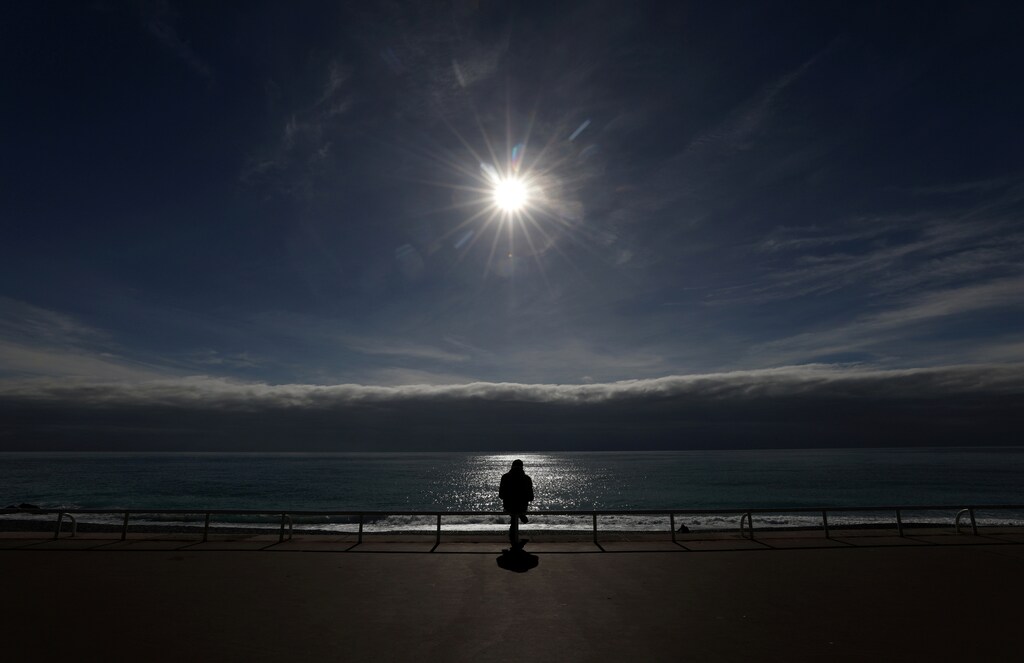 A man sits on the Promenade des Anglais in Nice amid the coronavirus disease (COVID-19) outbreak in France, February 16, 2021. REUTERS/Eric Gaillard TPX IMAGES OF THE DAY - RC2QTL90HGS4