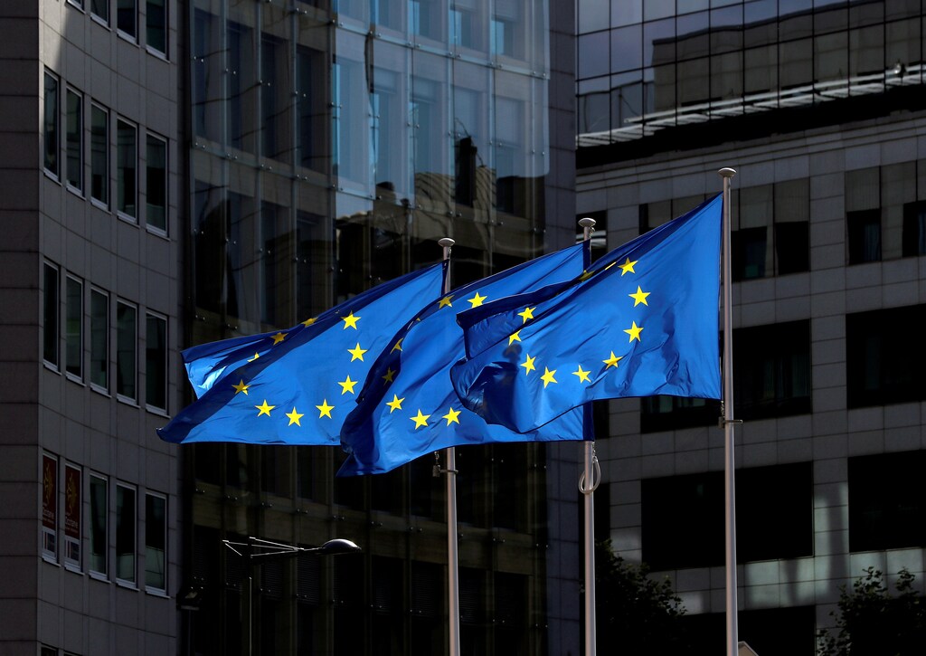 European Union flags flutter outside the European Commission headquarters in Brussels, Belgium, as the EU strengthens its cybersecurity legislation.