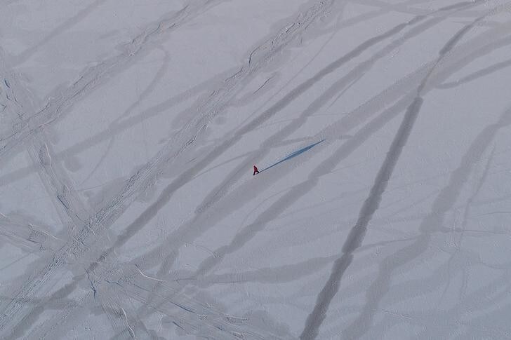 An aerial view shows a man walking along the Yenisei River covered with thin ice, with the air temperature at about minus 25 degrees Celsius (minus 13 degrees Fahrenheit), outside Krasnoyarsk, Russia January 2, 2018. REUTERS/Ilya Naymushin
