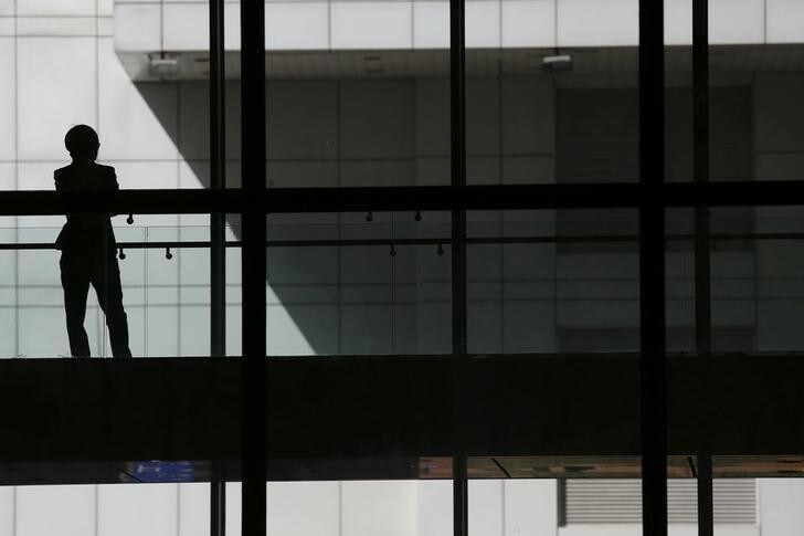 A woman talks on phone inside the Bank of China head office building in Beijing, China March 30, 2016. REUTERS/Damir Sagolj