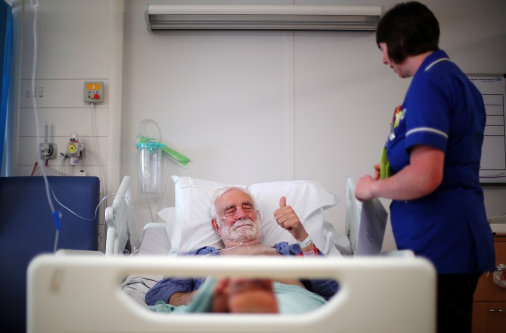 Inpatient Donald Ritson lies in bed in Ward 24 in Milton Keynes University Hospital in Milton Keynes, central England, Britain, May 22, 2018. "I've had so many things go wrong with my body in the last four-and-a-half years that it's just incredible that one organisation can cure so many things and treat me so kindly, efficiently, and for free. It's just astonishing,Ó said Ritson. He remembers what it was like before the state-funded NHS, when healthcare was beyond the reach of many people because they could not afford to pay doctors' fees. "I can remember my brother being ill and my parents being unable to afford to go to a doctor, so they tried to treat it themselves," he recalled. "We could never go back to that sort of system. Cradle to grave, it's not a bad idea." REUTERS/Hannah McKay