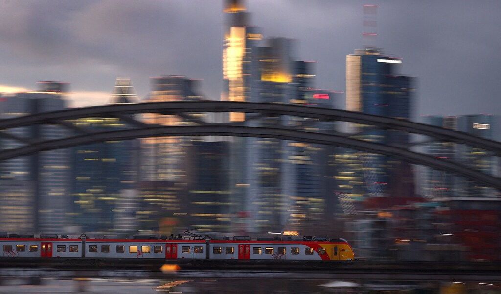 FILE PHOTO: A commuter train passes the skyline in a slow shutter speed photograph as the spread of the coronavirus disease (COVID-19) continues and the country faces new restrictions to control the pandemic in Frankfurt, Germany, December 2, 2021. REUTERS/Kai Pfaffenbach/File Photo GLOBAL BUSINESS WEEK AHEAD