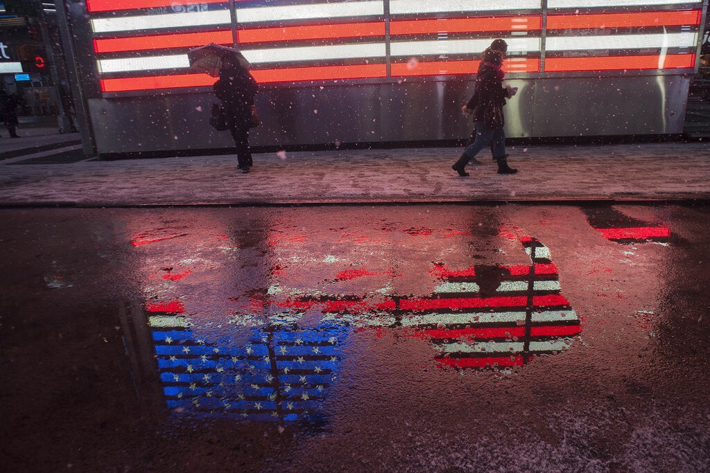 People make their way through snow in New York's Times Square, February 8, 2013. A blizzard slammed into the northeastern United States on Friday, snarling traffic, disrupting thousands of flights and prompting five governors to declare states of emergency in the face of a fearsome snowstorm. REUTERS/Keith Bedford (UNITED STATES - Tags: ENVIRONMENT TPX IMAGES OF THE DAY) - RTR3DIUQ