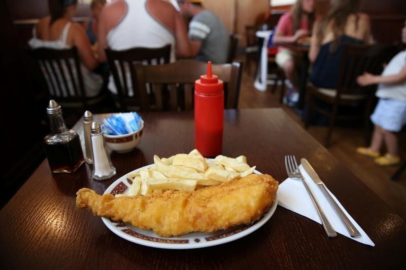 Fish and chips are seen at a table in Clacton-on-Sea, a town in eastern England, where 70 percent of people voted on June 23, 2016 to leave the European Union, Britain August 22, 2016. REUTERS/Neil Hall SEARCH "CLACTON BREXIT" FOR THIS STORY. SEARCH "WIDER IMAGE" FOR ALL STORIES. - S1AETYPCFPAB