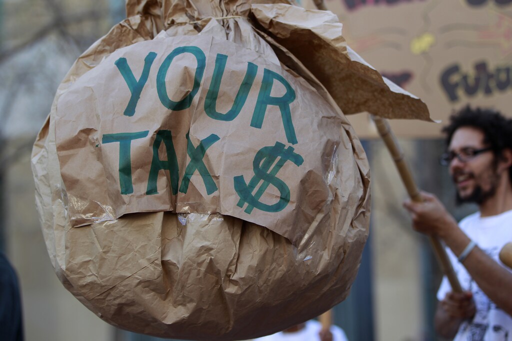 A demonstrator holds a paper-mache during a tax day protest outside Ronald V. Dellums Federal Building in Oakland, California April 17, 2012. REUTERS/Stephen Lam (UNITED STATES - Tags: POLITICS CIVIL UNREST BUSINESS) - RTR30VE5