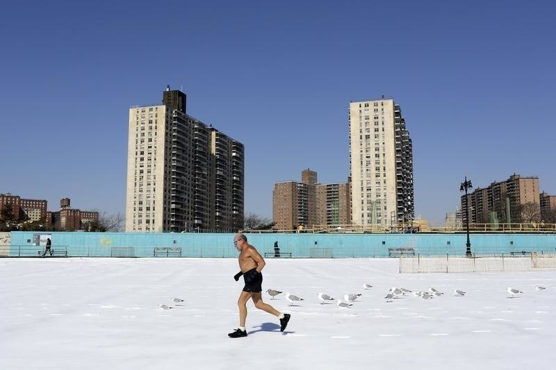 A man runs on the beach along Coney Island in the Brooklyn borough of New York March 2, 2015. Picture taken March 2, 2015. REUTERS/Youssef Boudlal (UNITED STATES - Tags: ENVIRONMENT SOCIETY TPX IMAGES OF THE DAY) - GM1EB331RBX01