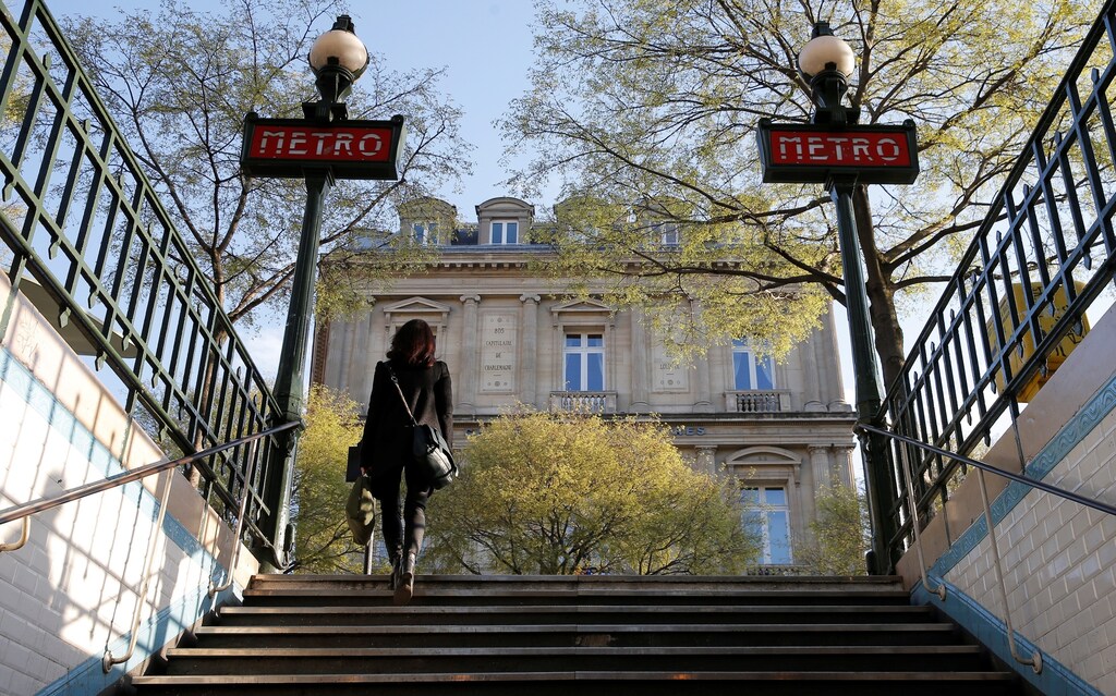 A woman leaves a metro entrance at the Chatelet station in Paris, France, March 28, 2017.