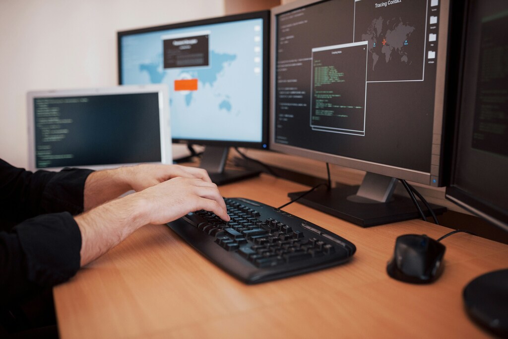 Hands at a keyboard as AI-powered scams increase in hiring processes.