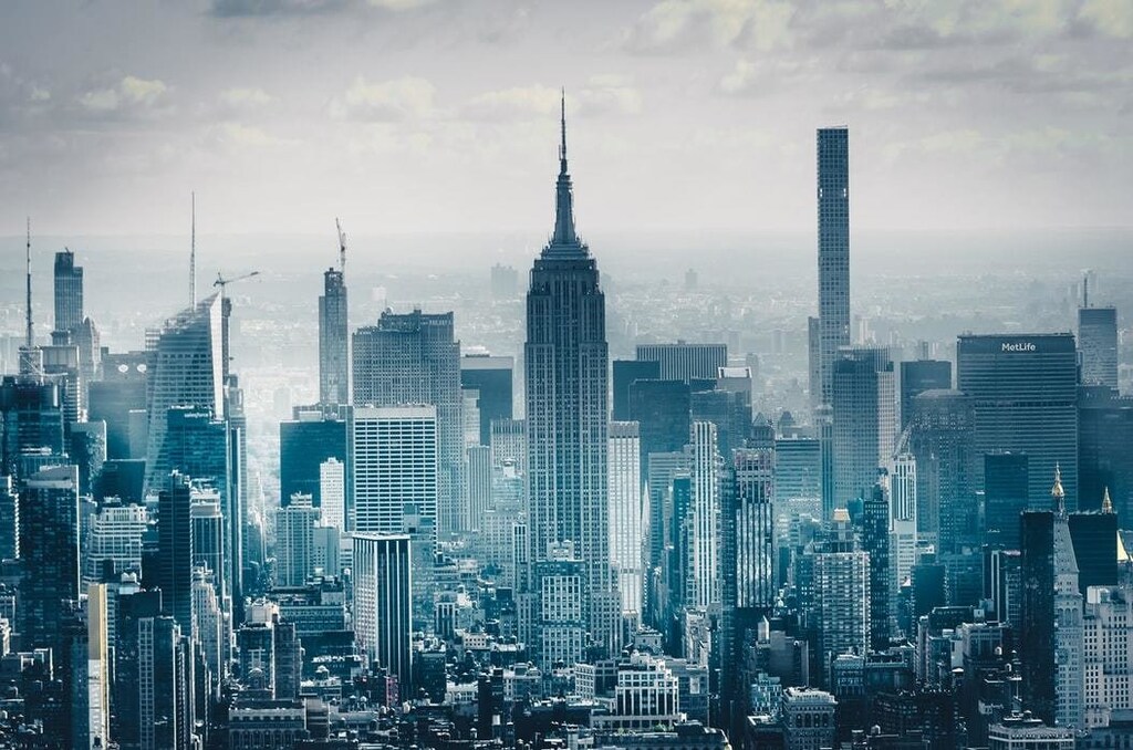 Skyscrapers are seen growing out of the city below.