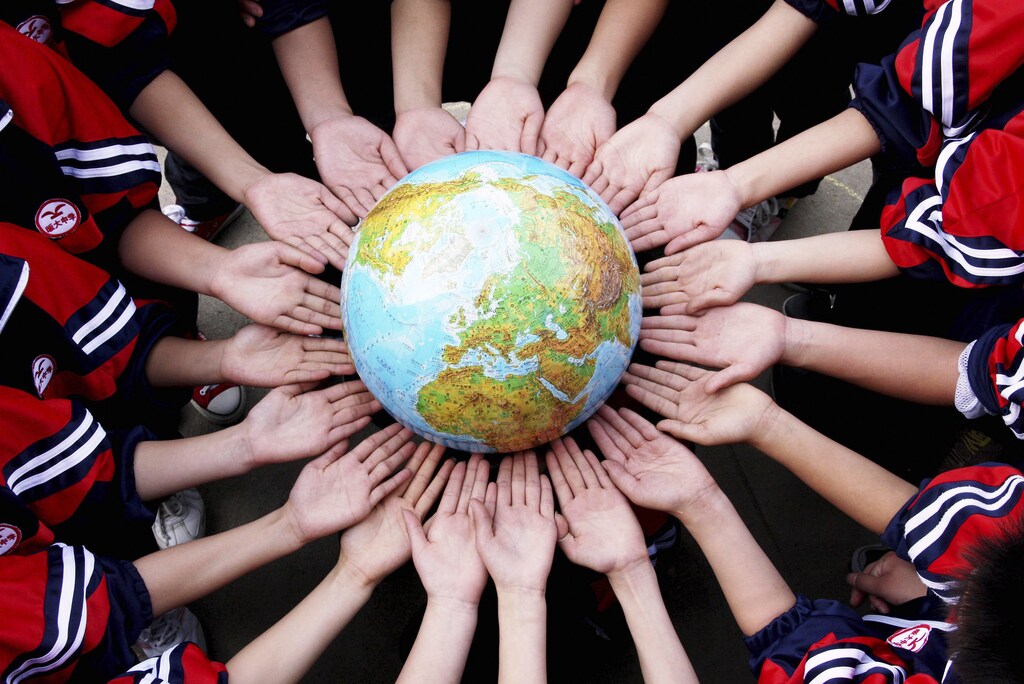 Students pose for a photo with a globe during a campaign to mark World Earth Day in a middle school in Dexing, Jiangxi province April 19, 2011. World Earth Day falls on April 22 every year. Picture taken April 19, 2011. REUTERS/China Daily (CHINA - Tags: ANNIVERSARY ENVIRONMENT EDUCATION IMAGES OF THE DAY) CHINA OUT. NO COMMERCIAL OR EDITORIAL SALES IN CHINA FOR BEST QUALITY IMAGE: ALSO SEE GM1E74L1H1701. - GM1E74K19J601