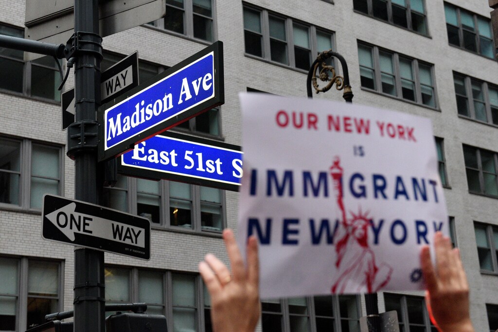 A protester holds up a sign while marching towards Trump Tower during a demonstration organized by the New York Immigration Coalition against President-elect Donald Trump in the Manhattan borough of New York, U.S., December 18, 2016. REUTERS/Darren Ornitz - RTX2VL0T