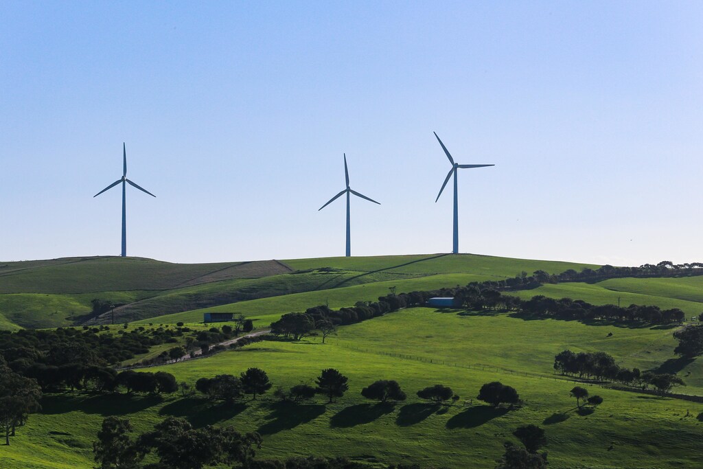 the green energy transition, such as these wind turbines, will need to accelerate in order to meet climate change goals