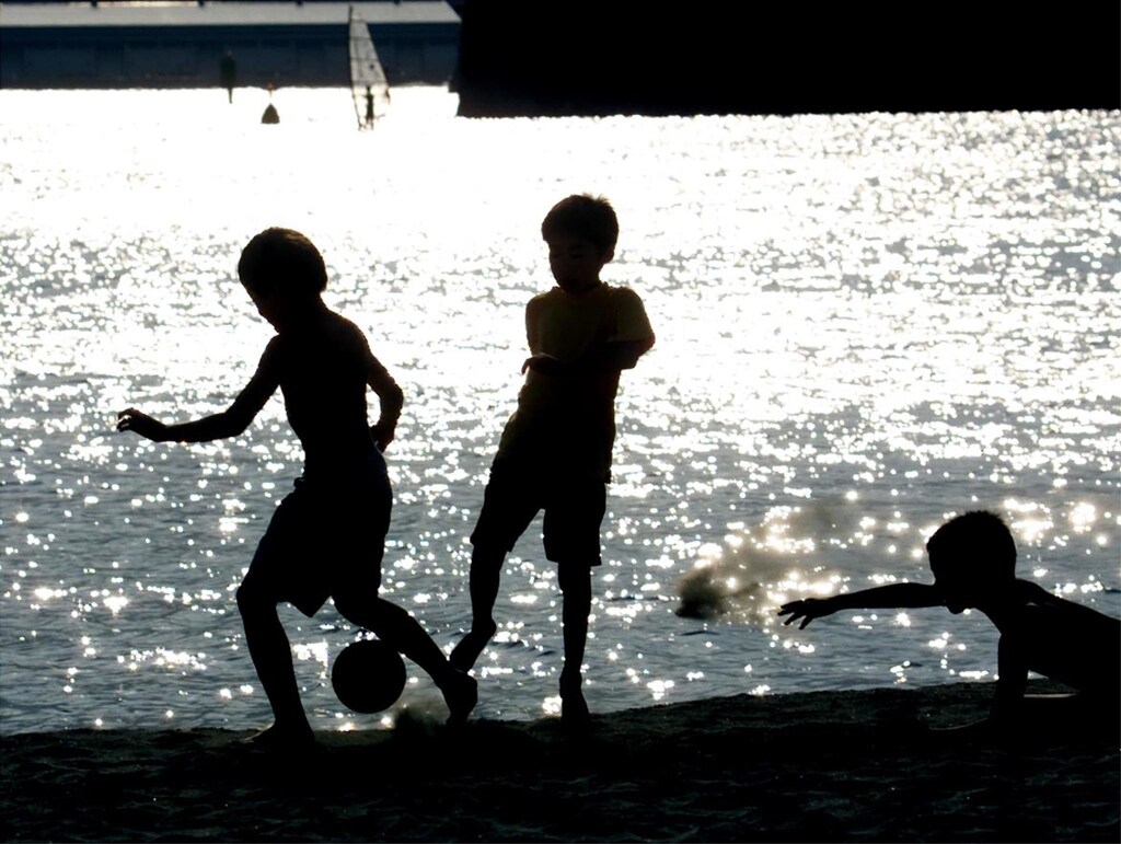 Japanese boys play soccer on a beach near central Tokyo May 5. Recent surveys of Japan's youth said that soccer has overtaken long-time favourite baseball as the most popular sport for the nation's schoolchildren. Soccer was expected to gain even more in the sports popularity rankings as Japan co-hosts the soccer World Cup Finals in 2002.KM/DL - RP2DRHXPGGAE